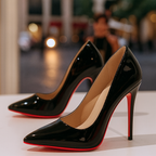 Pair of womens black heels with pointed toe and high-shine finish