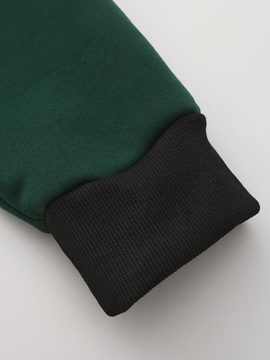 Mens zip up hoodie in Green, close-up of the sleeve and black cuff