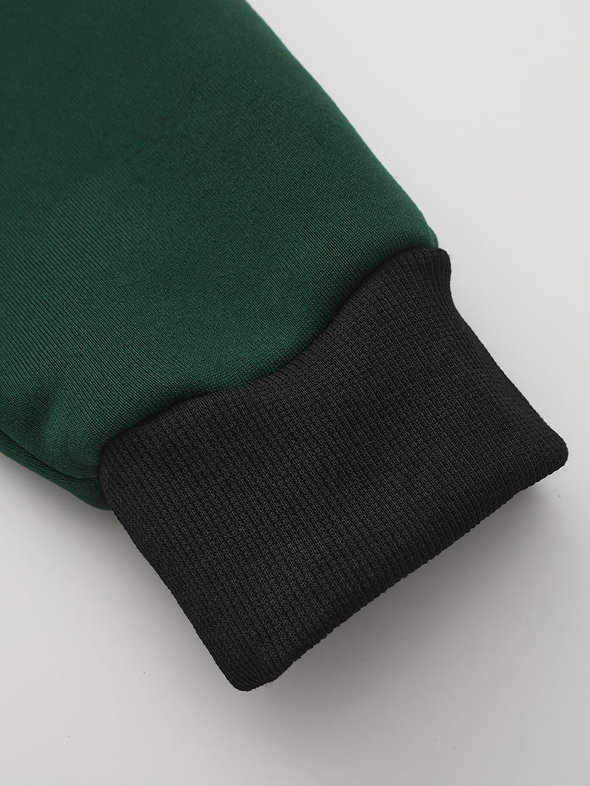 Mens zip up hoodie in Green, close-up of the sleeve and black cuff
