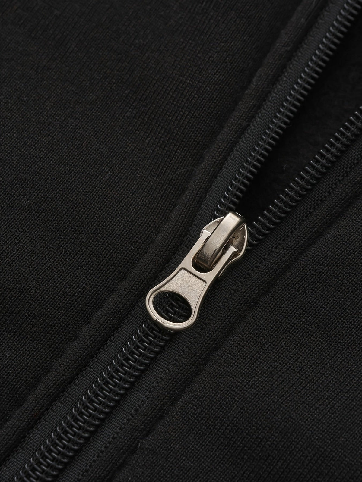 Mens zip up hoodie, close-up of the zip on the black body