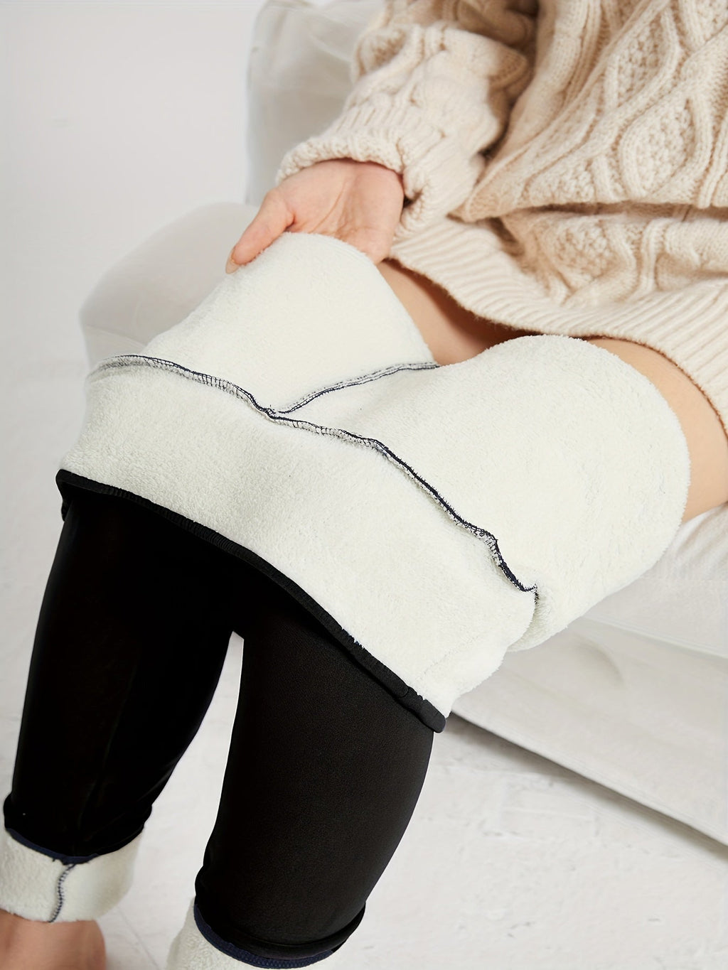 Womens fleece lined leggings in Black, lining shown at the leg