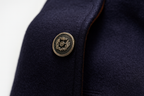 Mens overcoat in Navy, close-up of a metal button