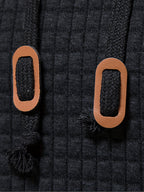 Mens waffle knit hoodie in Black, close-up of the cord tabs