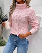 Womens cable knit sweater in Pink with turtleneck, worn with jeans