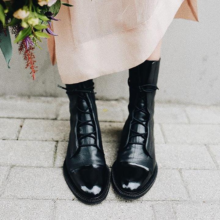 Womens lace up boots in Black worn with a pink skirt