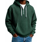 Mens quarter zip hoodie in Green, front view worn with jeans