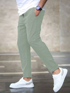 Mens casual pants in Mint, tapered leg with drawstring waist, worn with white sneakers