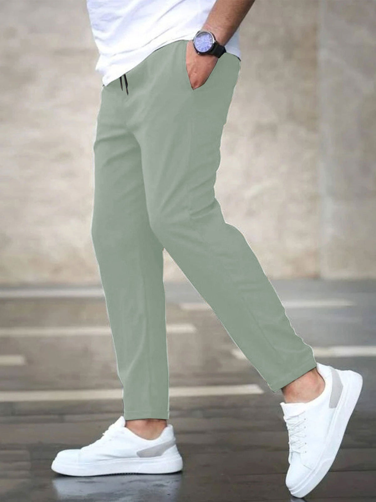Mens casual pants in Mint, tapered leg with drawstring waist, worn with white sneakers