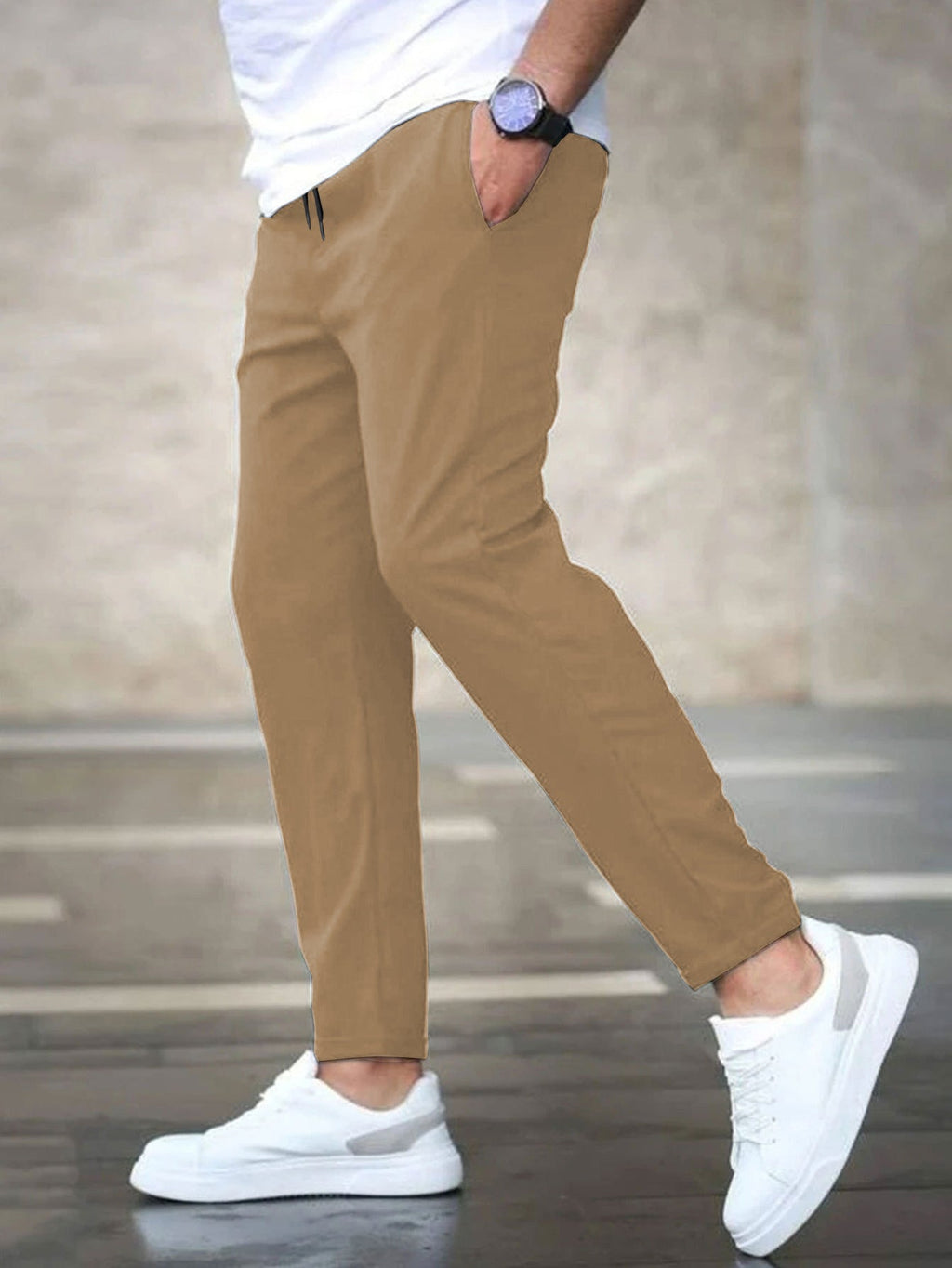 Mens casual pants in Khaki, tapered leg with drawstring waist, worn with white sneakers