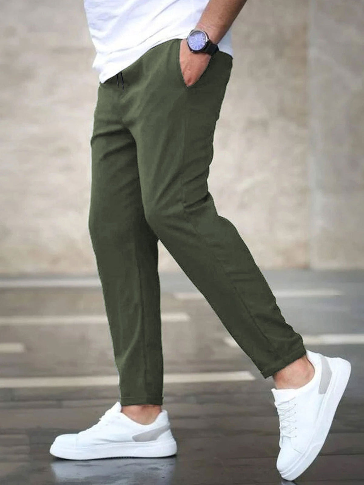 Mens casual pants in Olive, tapered leg with drawstring waist, worn with white sneakers