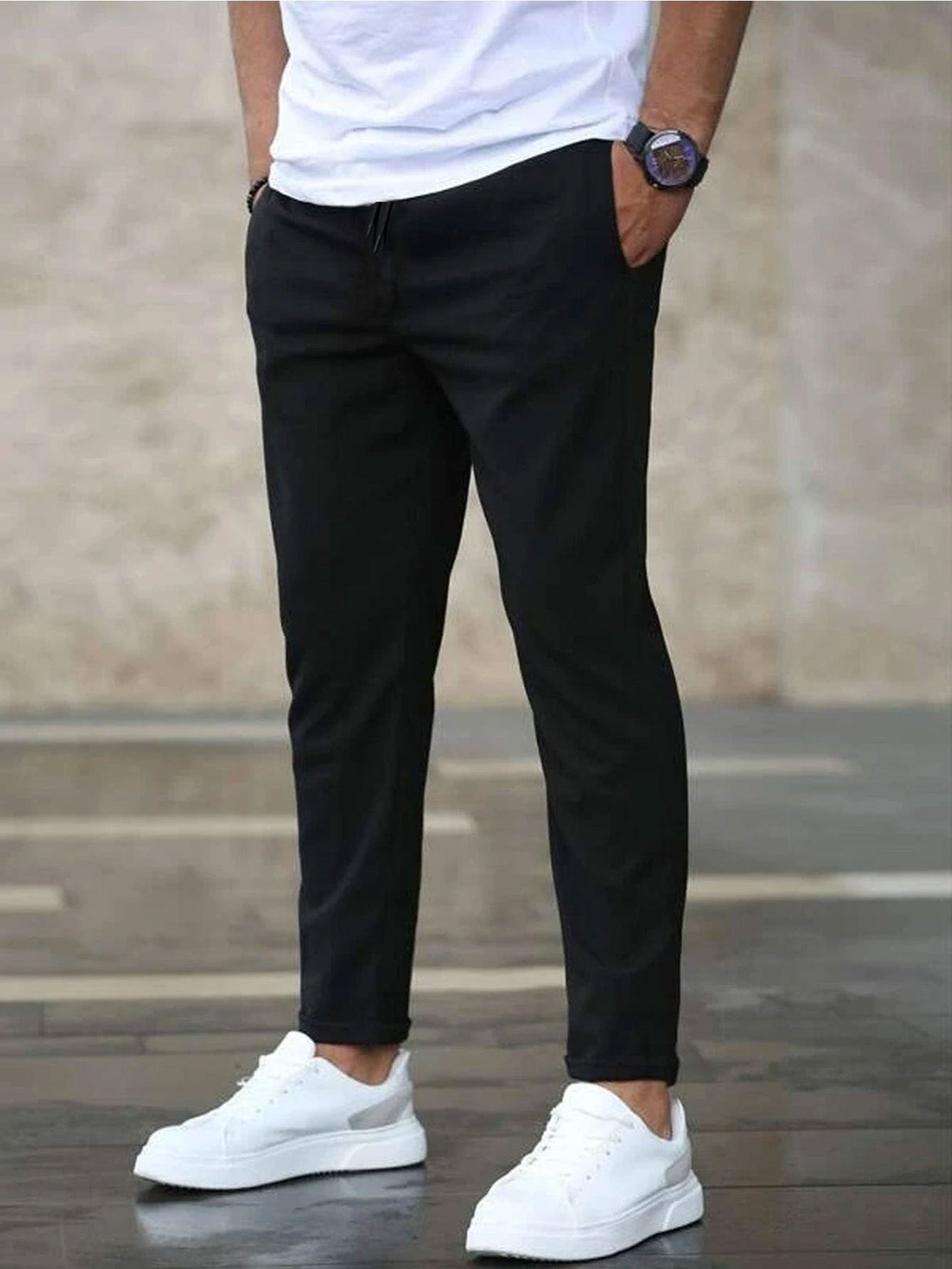 Mens casual pants in Black, tapered leg with drawstring waist, worn with white sneakers
