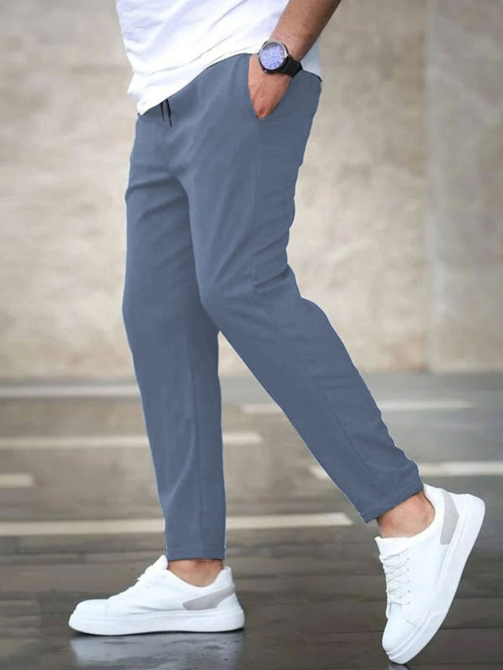 Mens casual pants in Blue, tapered leg with drawstring waist, worn with white sneakers