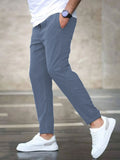 Mens casual pants in Blue, tapered leg with drawstring waist, worn with white sneakers