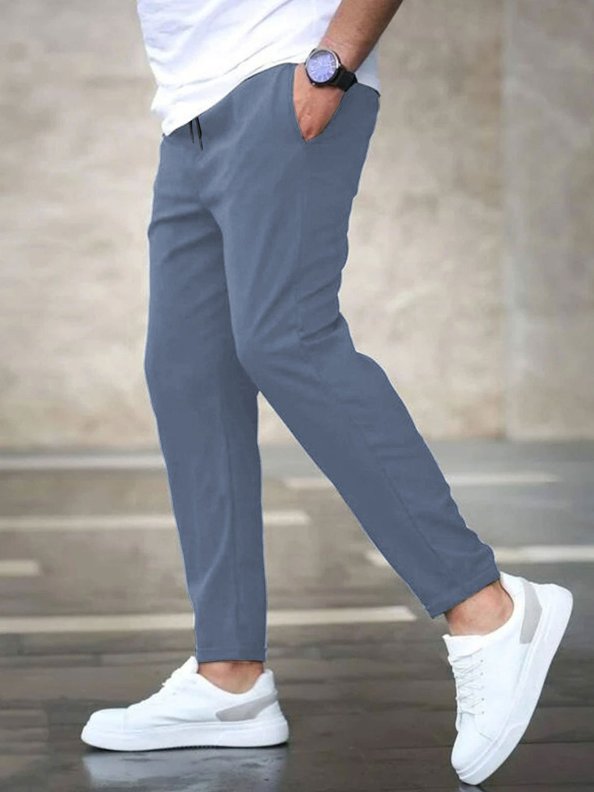 Mens casual pants in Blue, tapered leg with drawstring waist, worn with white sneakers