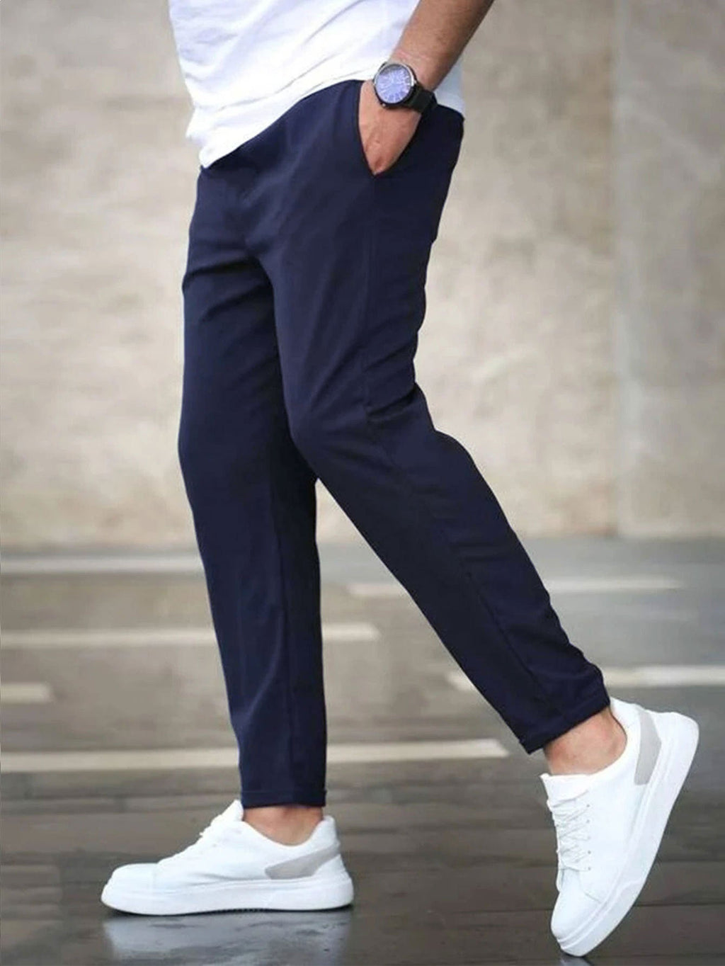 Mens casual pants in Navy, tapered leg with drawstring waist, worn with white sneakers
