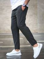 Mens casual pants in Charcoal, tapered leg with drawstring waist, worn with white sneakers