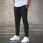 Mens casual pants in Charcoal, tapered leg with drawstring waist, worn with white sneakers