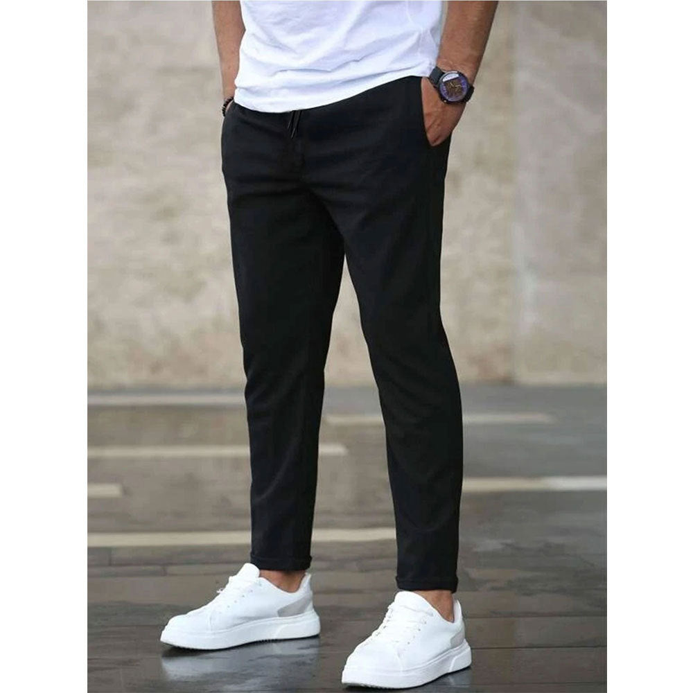Mens casual pants in Black, tapered leg with drawstring waist, worn with white sneakers