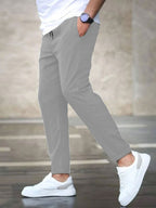 Mens casual pants in Gray, tapered leg with drawstring waist, worn with white sneakers