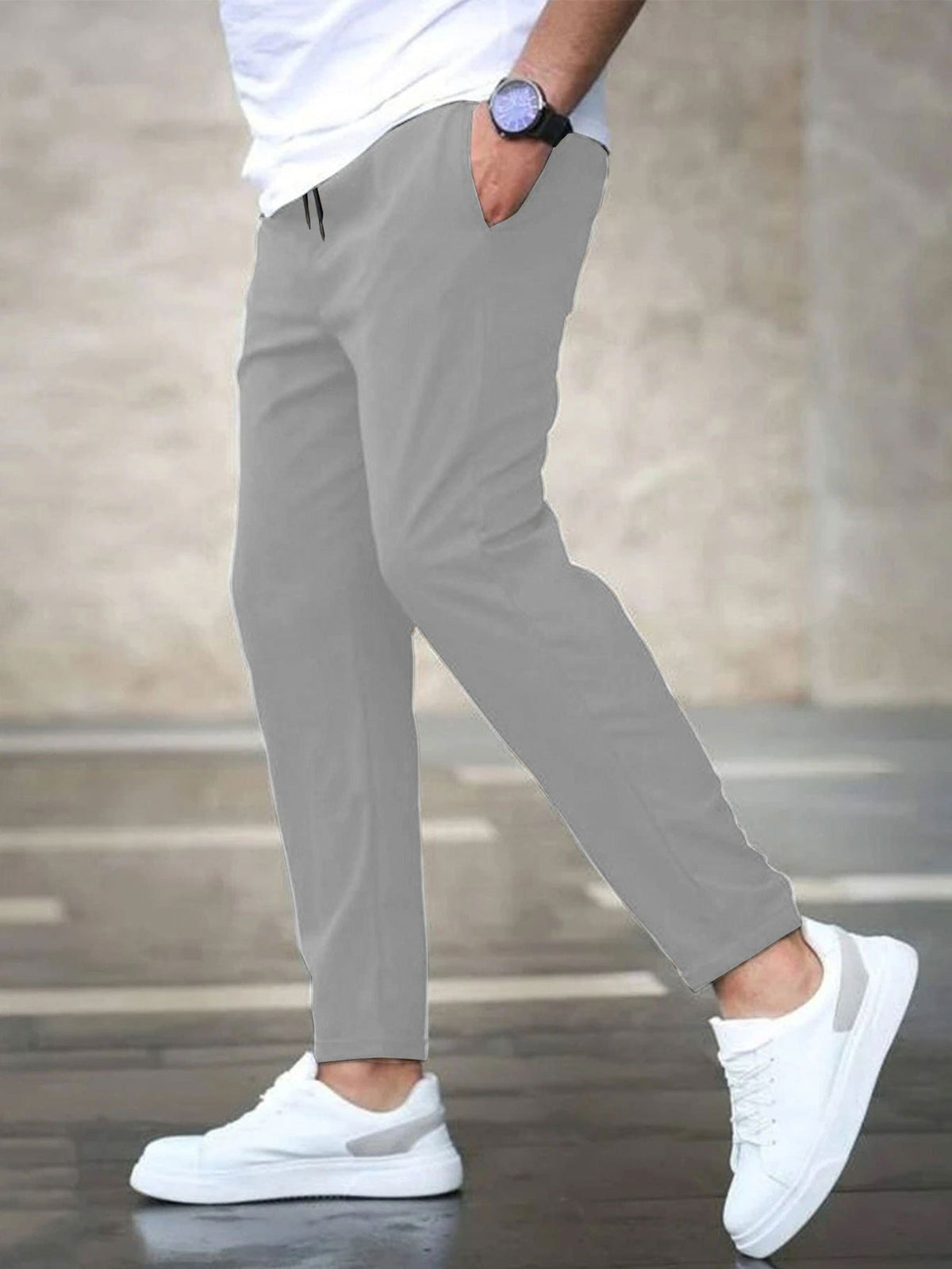 Mens casual pants in Gray, tapered leg with drawstring waist, worn with white sneakers