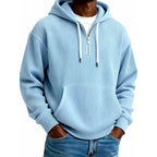 Mens quarter zip hoodie in Light Blue, front view worn with jeans