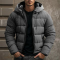 Mens puffer jacket in Gray with drawstring hood, worn over a black tee
