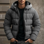 Mens puffer jacket in Gray with drawstring hood, worn over a black tee