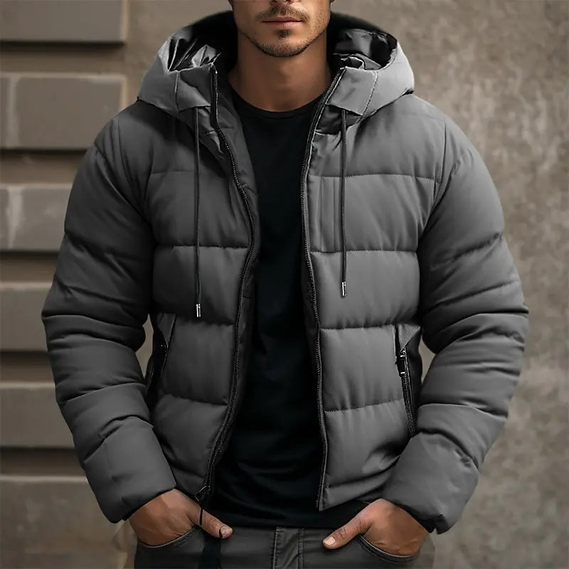 Mens puffer jacket in Gray with drawstring hood, worn over a black tee