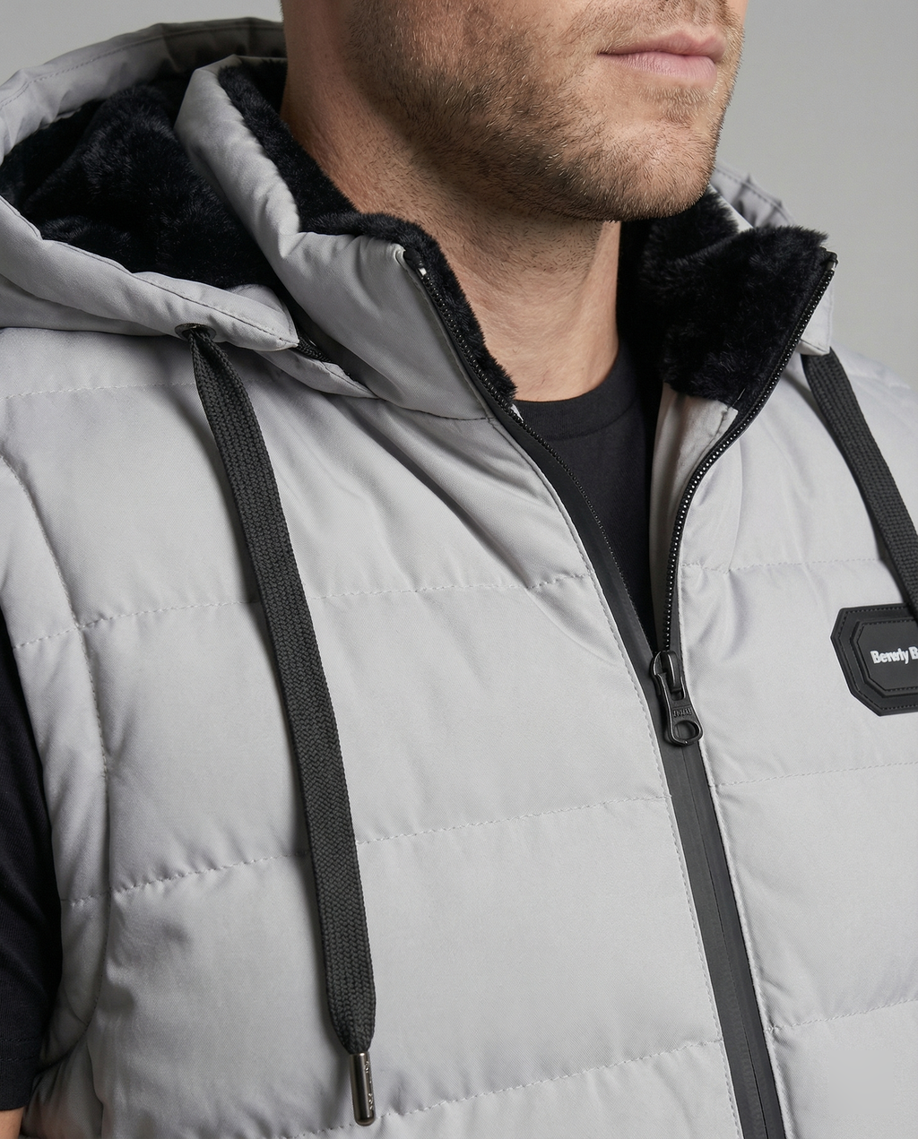 Mens puffer vest with hood in Gray, close-up of the zip and fleece lined hood