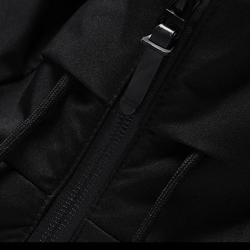 Puffer jacket in Black, close-up of the front zip and hood strap