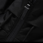 Puffer jacket in Black, close-up of the front zip and hood strap