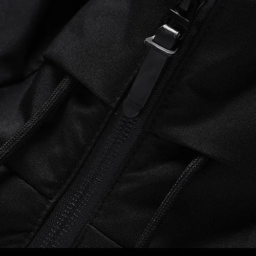 Puffer jacket in Black, close-up of the front zip and hood strap