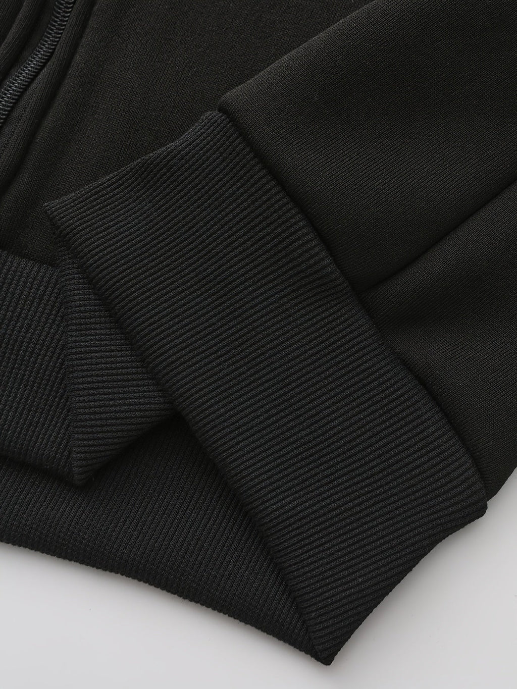 Mens zip up hoodie, close-up of the black ribbed cuff