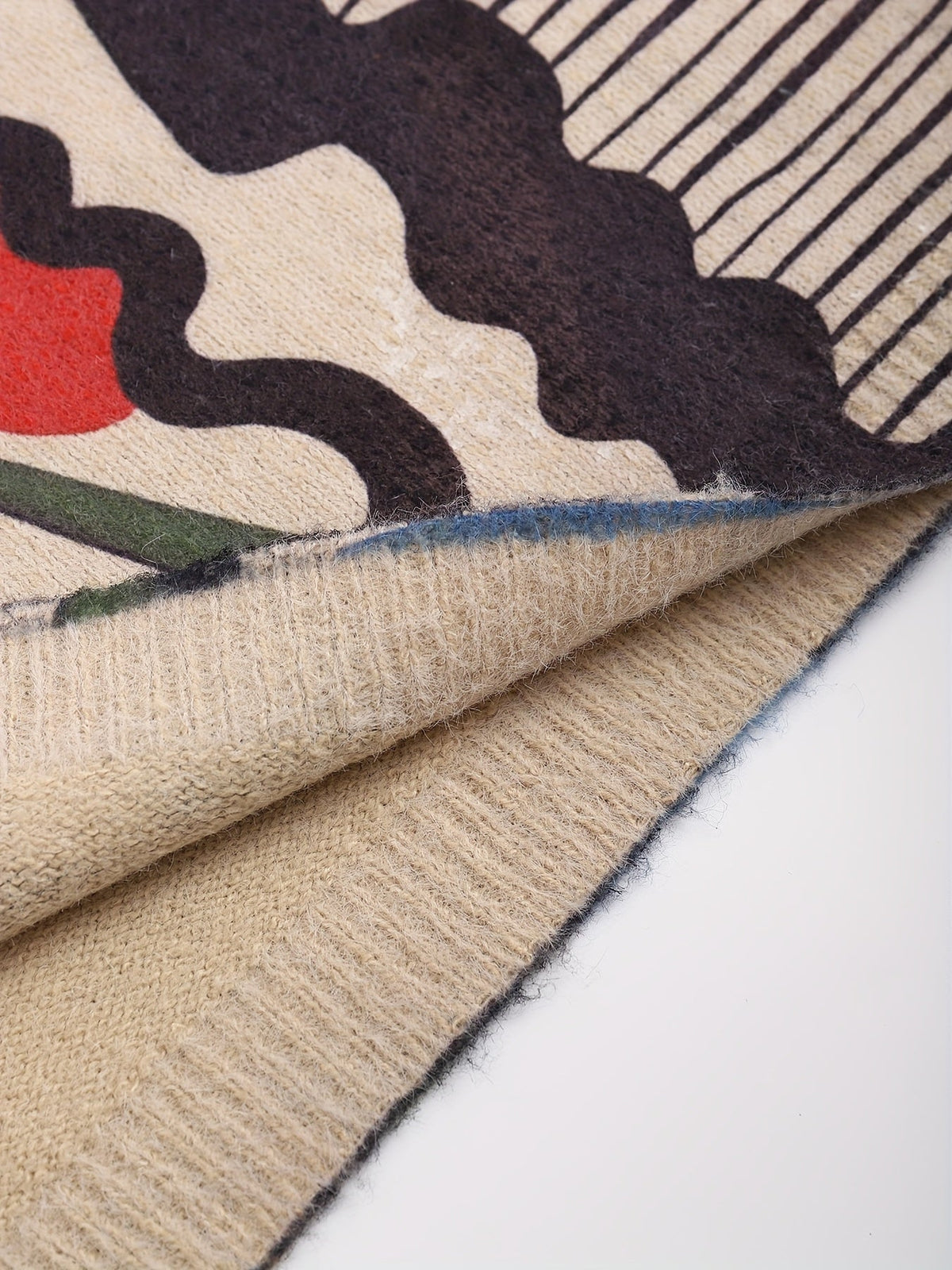 Mens crew neck sweater with abstract face print in Multicolor, close-up of the ribbed hem