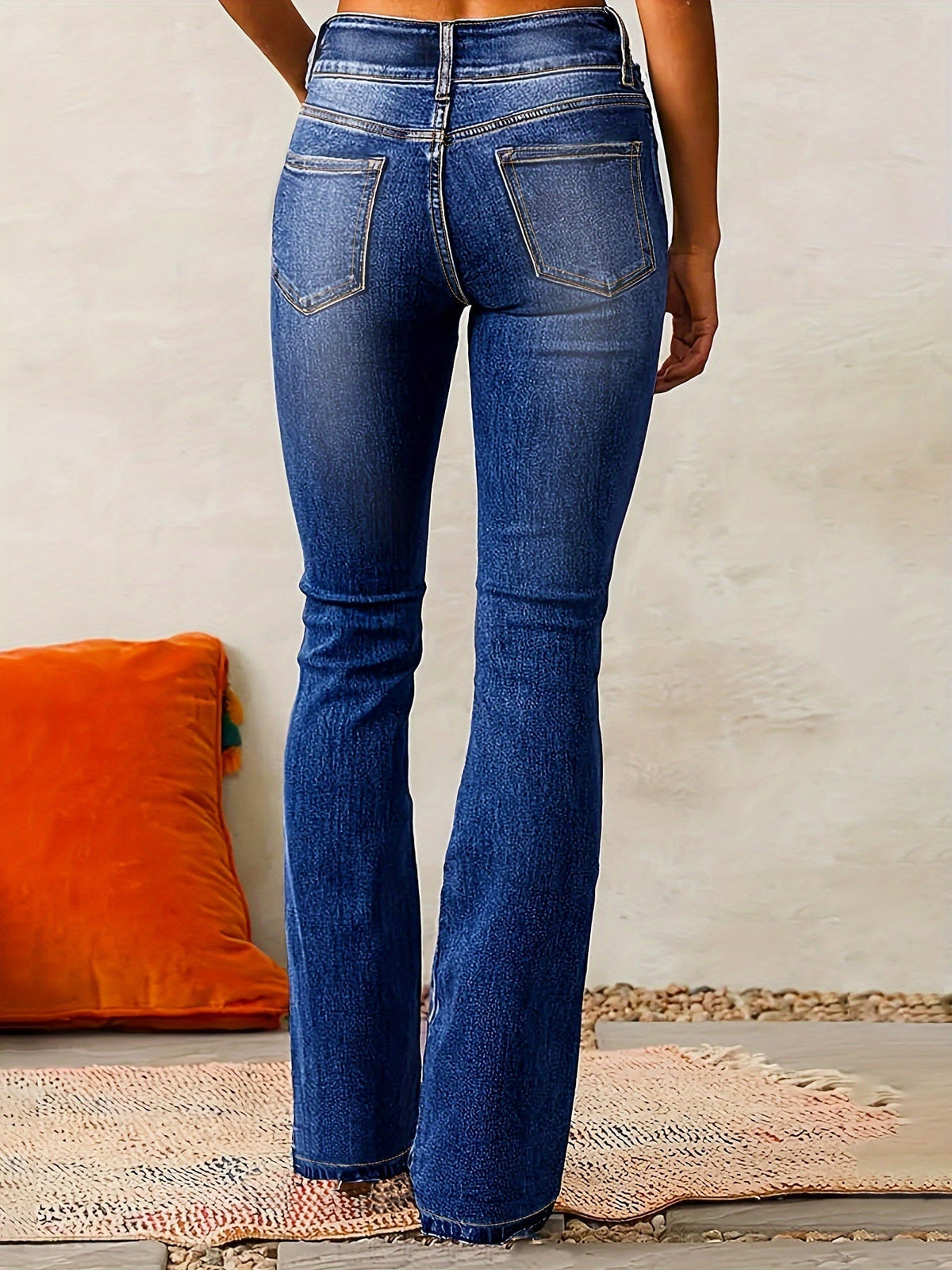 Womens flare jeans in Navy, back view of the flared leg