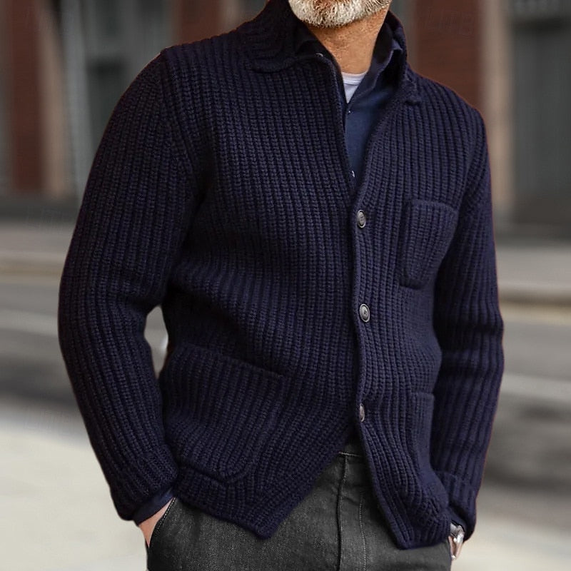 Mens cardigan in Navy with button front and patch pockets, worn over a shirt