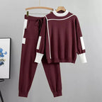 Womens tracksuit with contrast stripe trim in Burgundy, sweater and joggers on a hanger