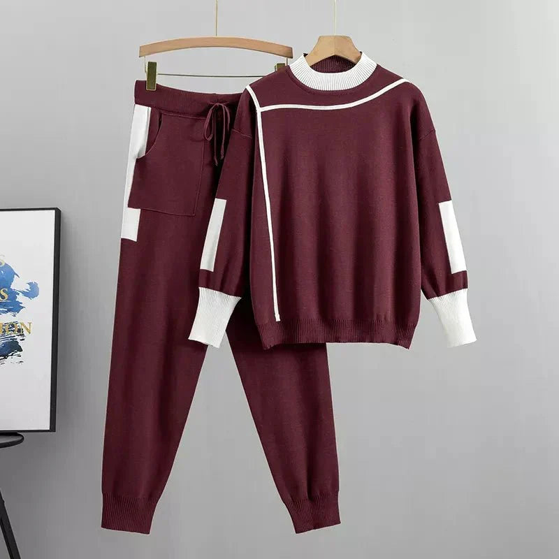 Womens tracksuit with contrast stripe trim in Burgundy, sweater and joggers on a hanger