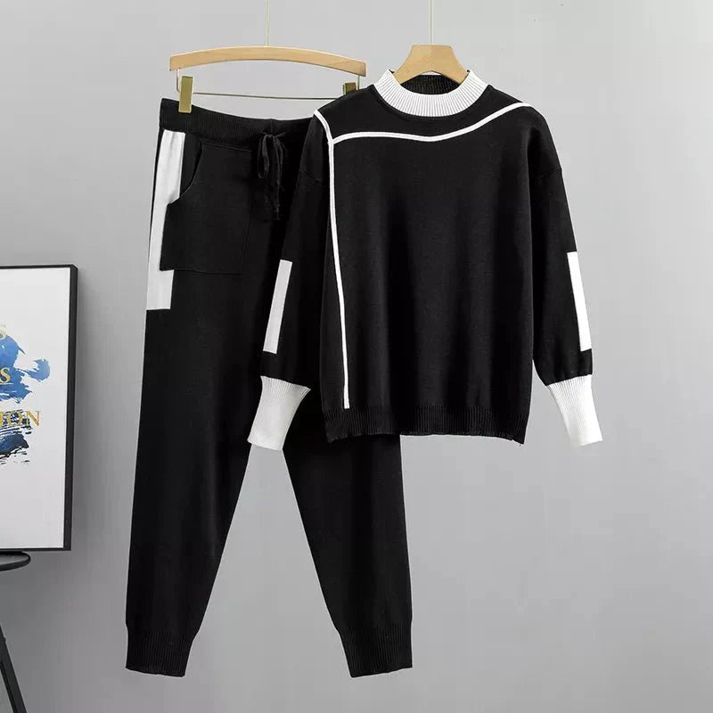Womens tracksuit with contrast stripe trim in Black, sweater and joggers on a hanger
