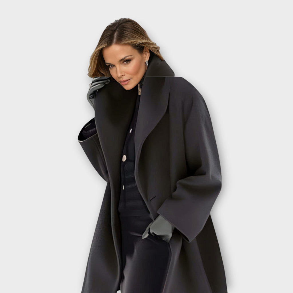 Womens wool coat with shawl collar in Black, swing cut, worn open over dark knitwear