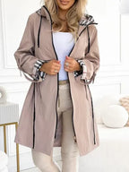 Womens waterproof jacket worn open with hood and drawstrings, front view