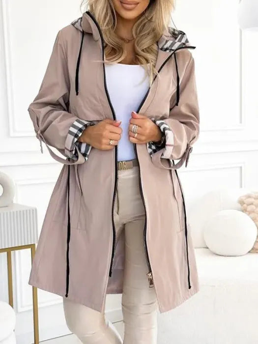 Womens waterproof jacket worn open with hood and drawstrings, front view