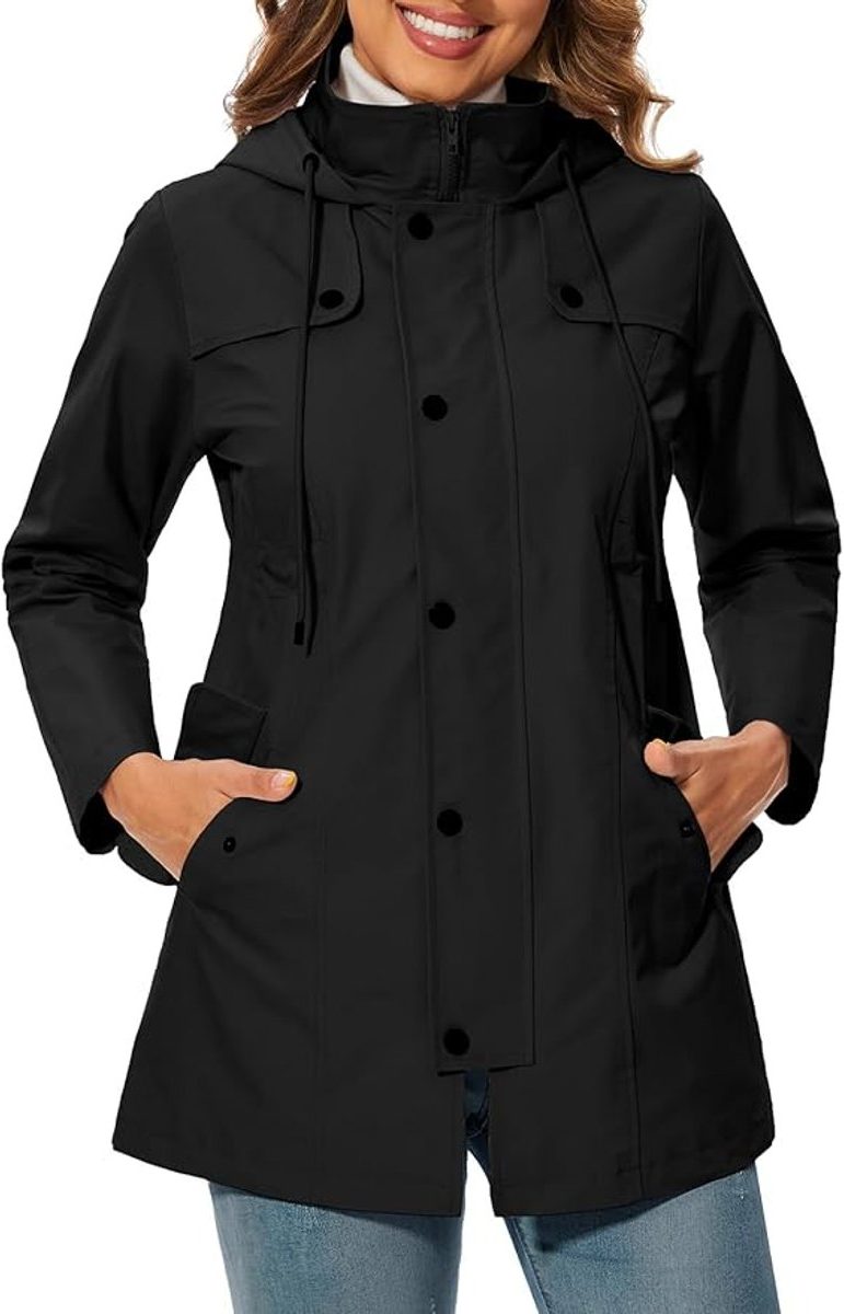 Womens rain jacket in Black, worn with the hood up and snap front closed