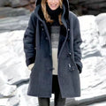 Womens winter coat in Blue with hood and toggle front, worn in the snow